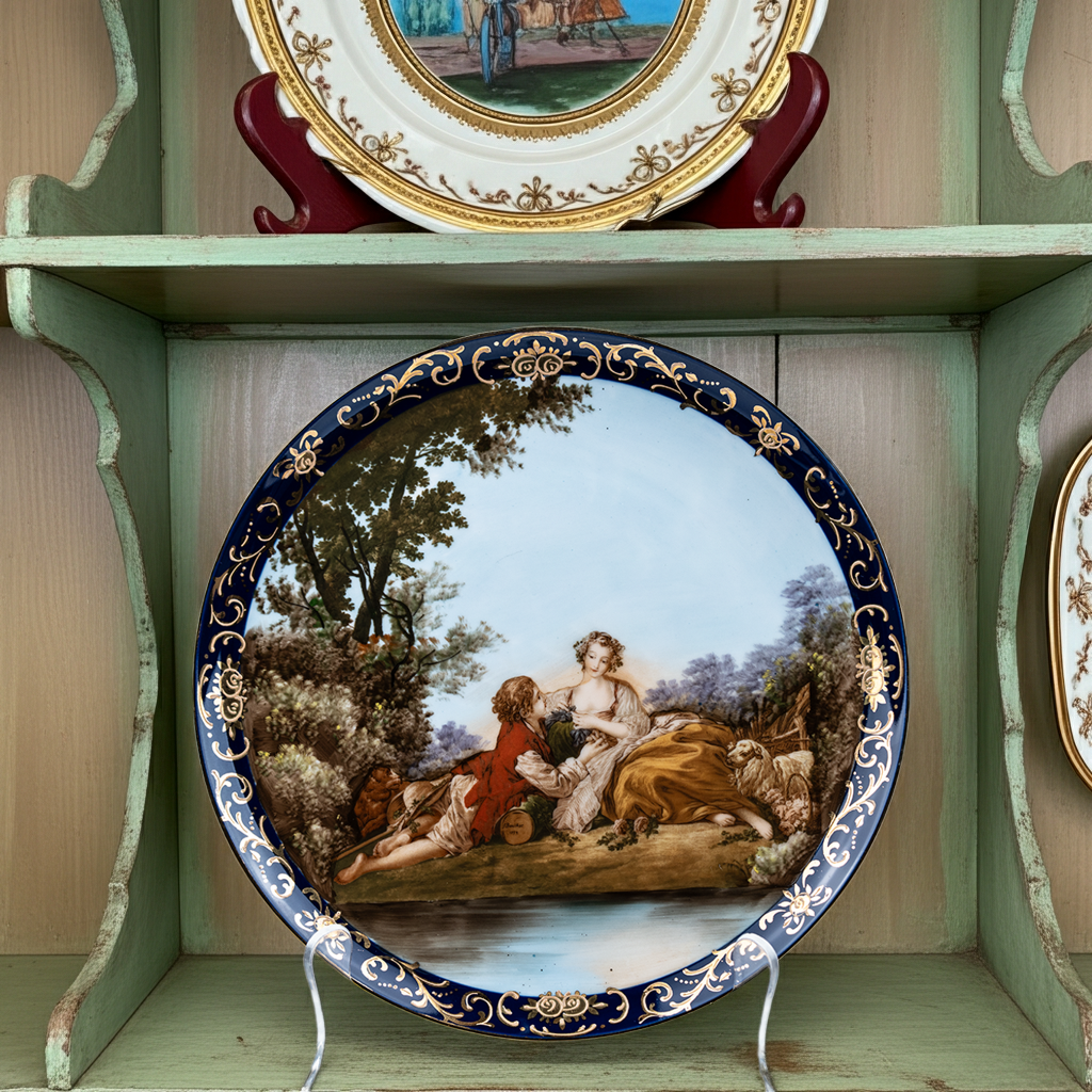 Hand‑Painted Courting Scene Plate with Cobalt Crust‑Gold Rim