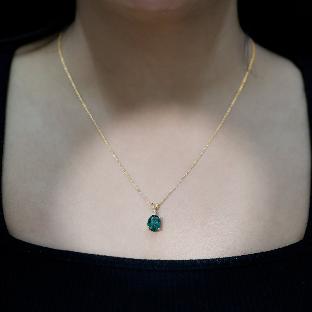 Oval Created Emerald and Moissanite Solitaire Pendant