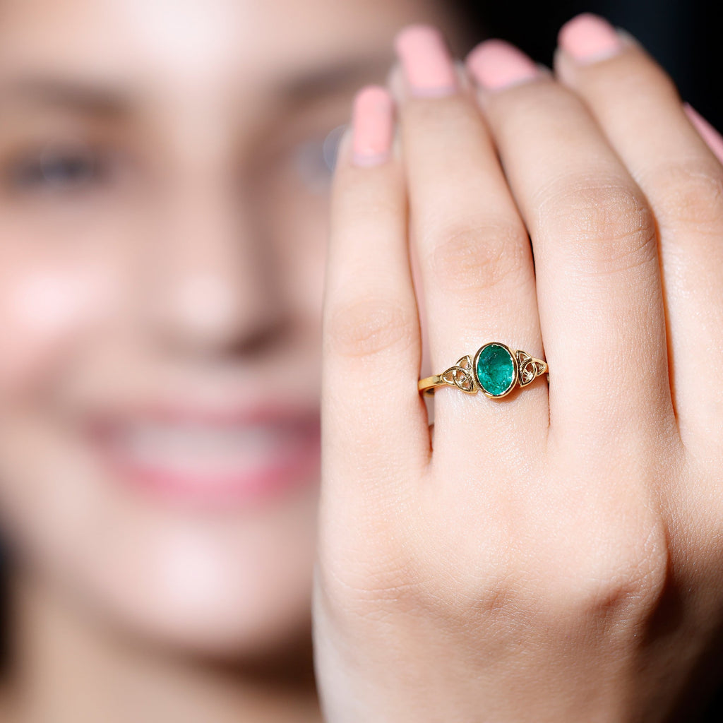 Oval Shaped Emerald Celtic Engagement Ring in Bezel Setting