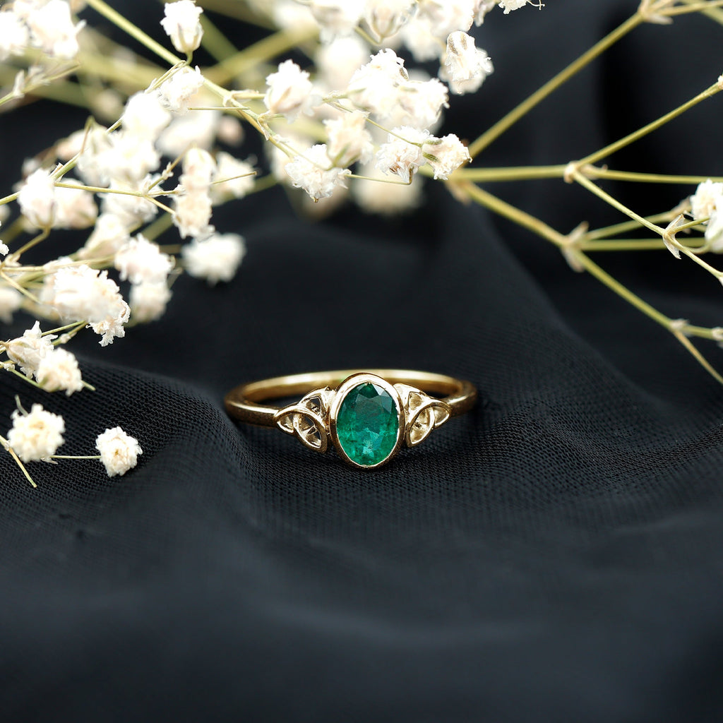 Oval Shaped Emerald Celtic Engagement Ring in Bezel Setting