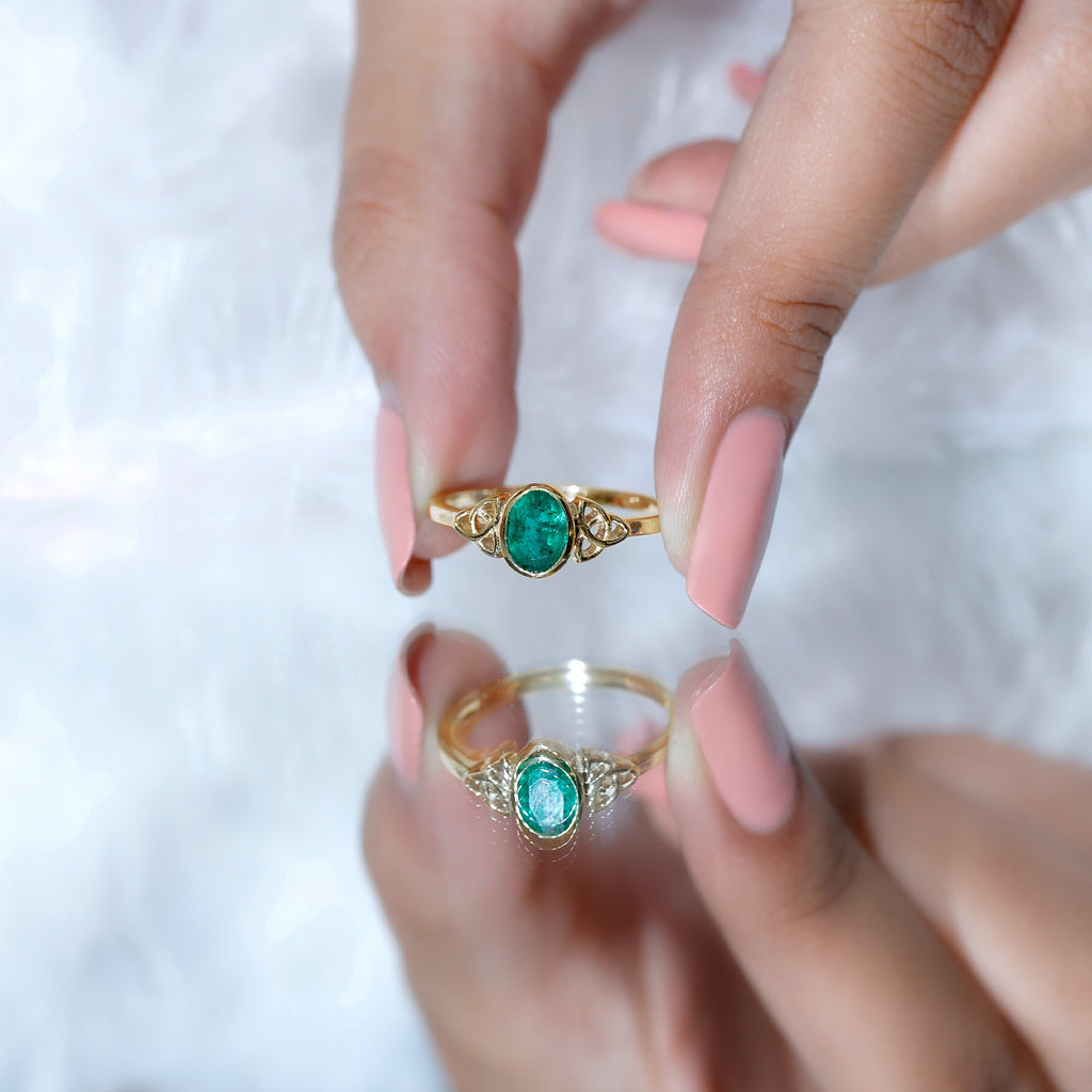 Oval Shaped Emerald Celtic Engagement Ring in Bezel Setting
