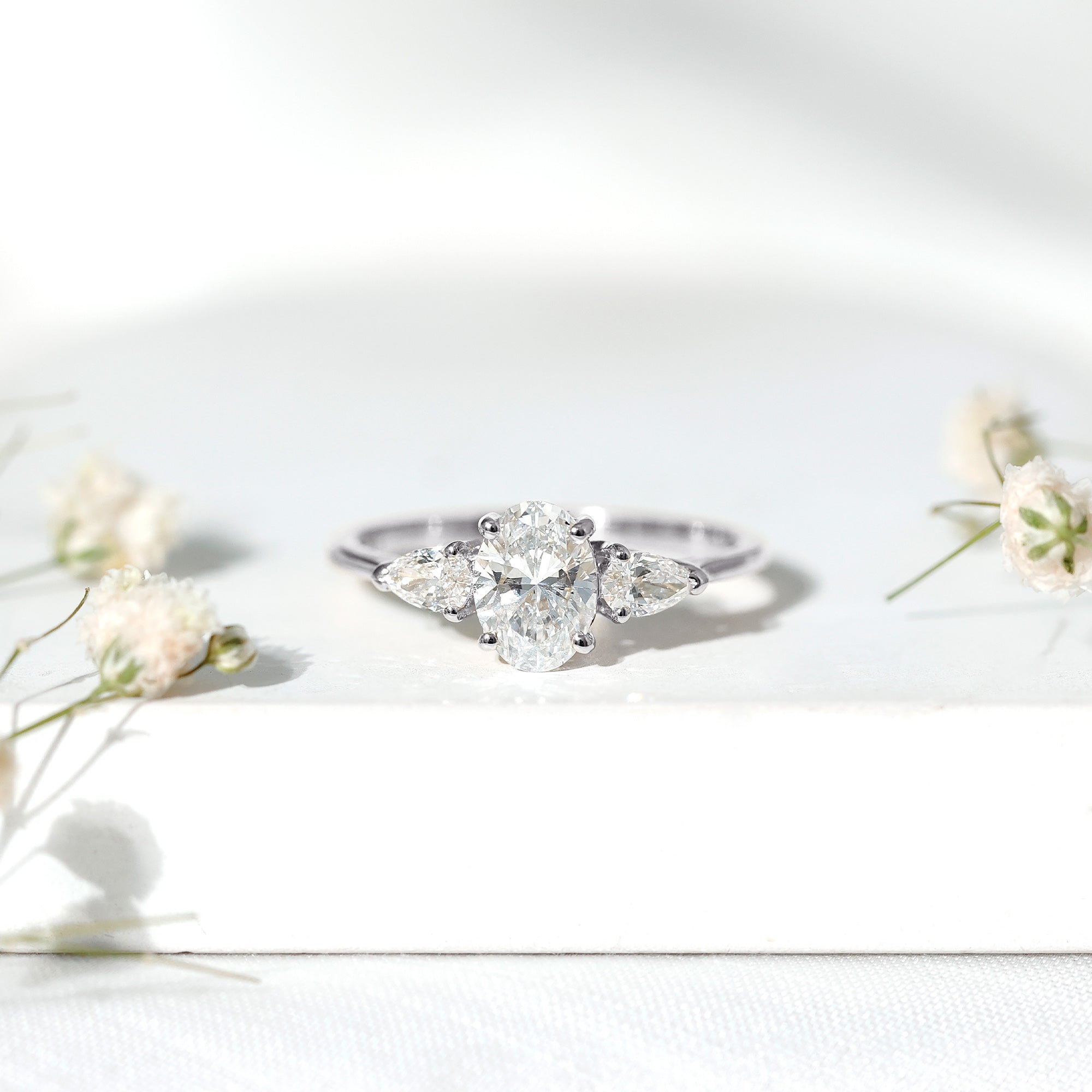 Oval and Pear Cut Moissanite Three Stone Engagement Ring