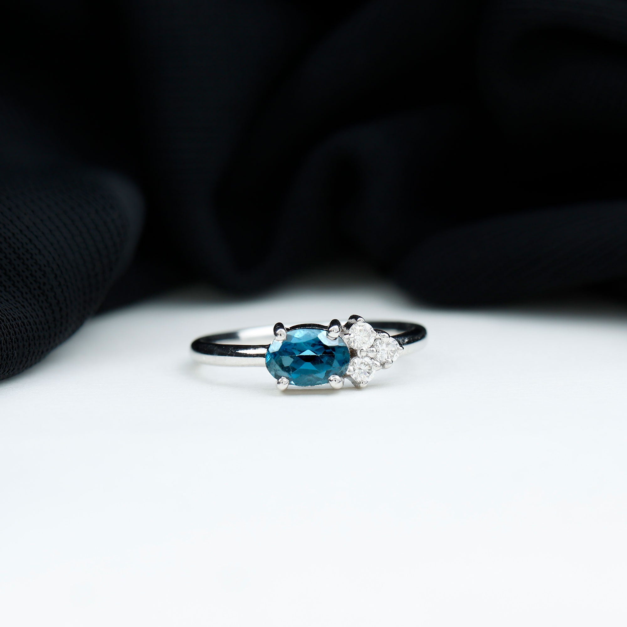 0.4 Carat Oval Cut London Blue Topaz East West Promise Ring with Diamond Trio