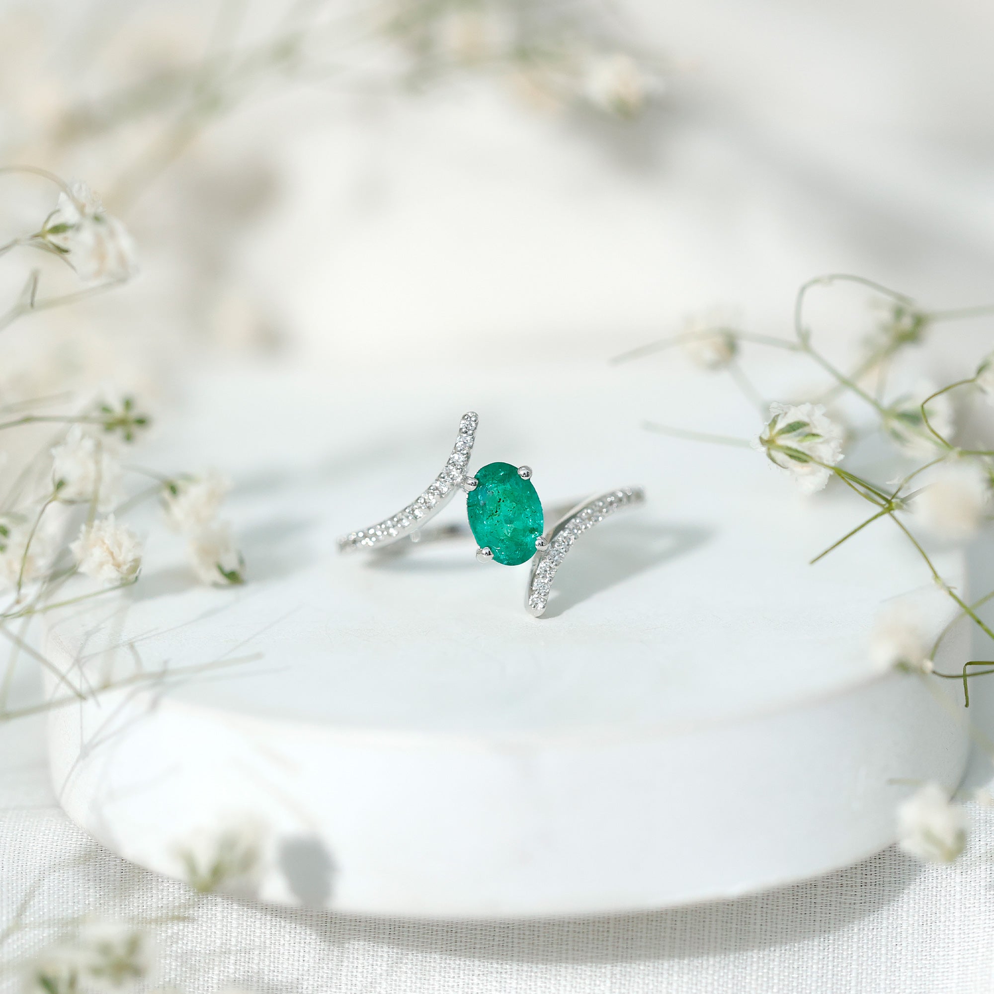 Oval Shaped Emerald Bypass Engagement Ring with Diamonds