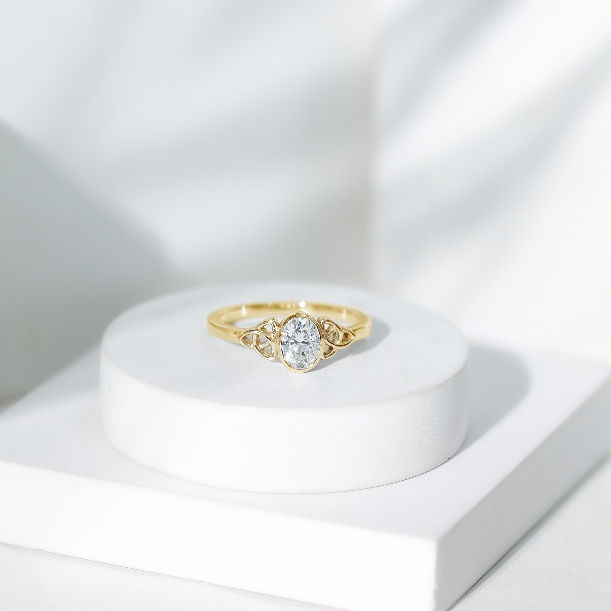 Oval Moissanite Solitaire Celtic Knot Ring in Bezel Setting