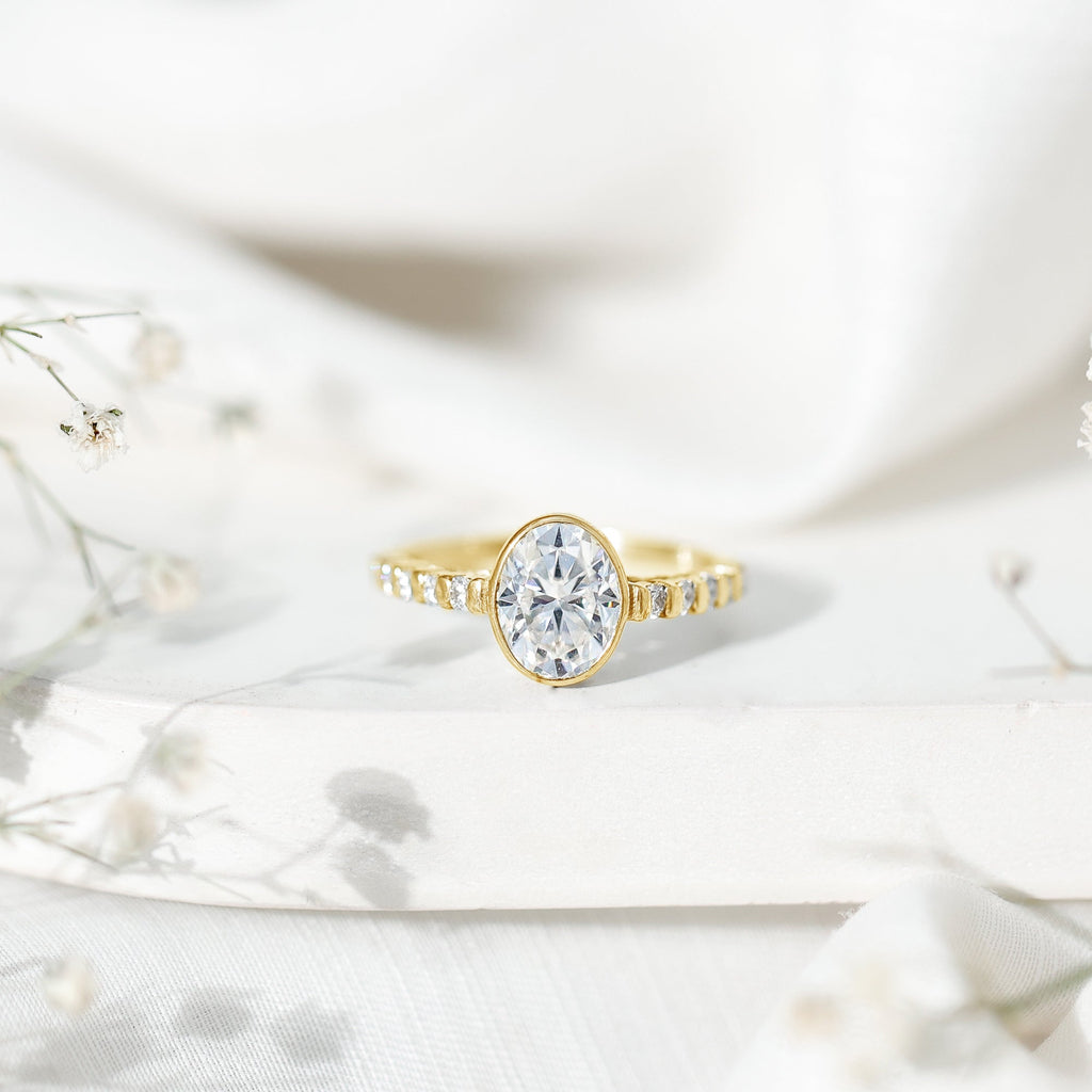Bezel Set Moissanite Oval Engagement Ring with Side Stones