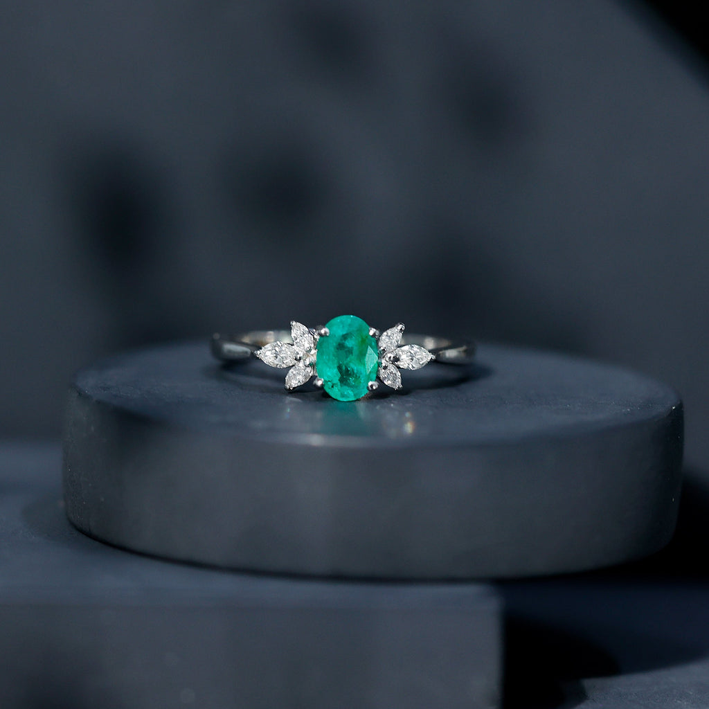 Oval Shaped Emerald Engagement Ring with Marquise Diamond Trio