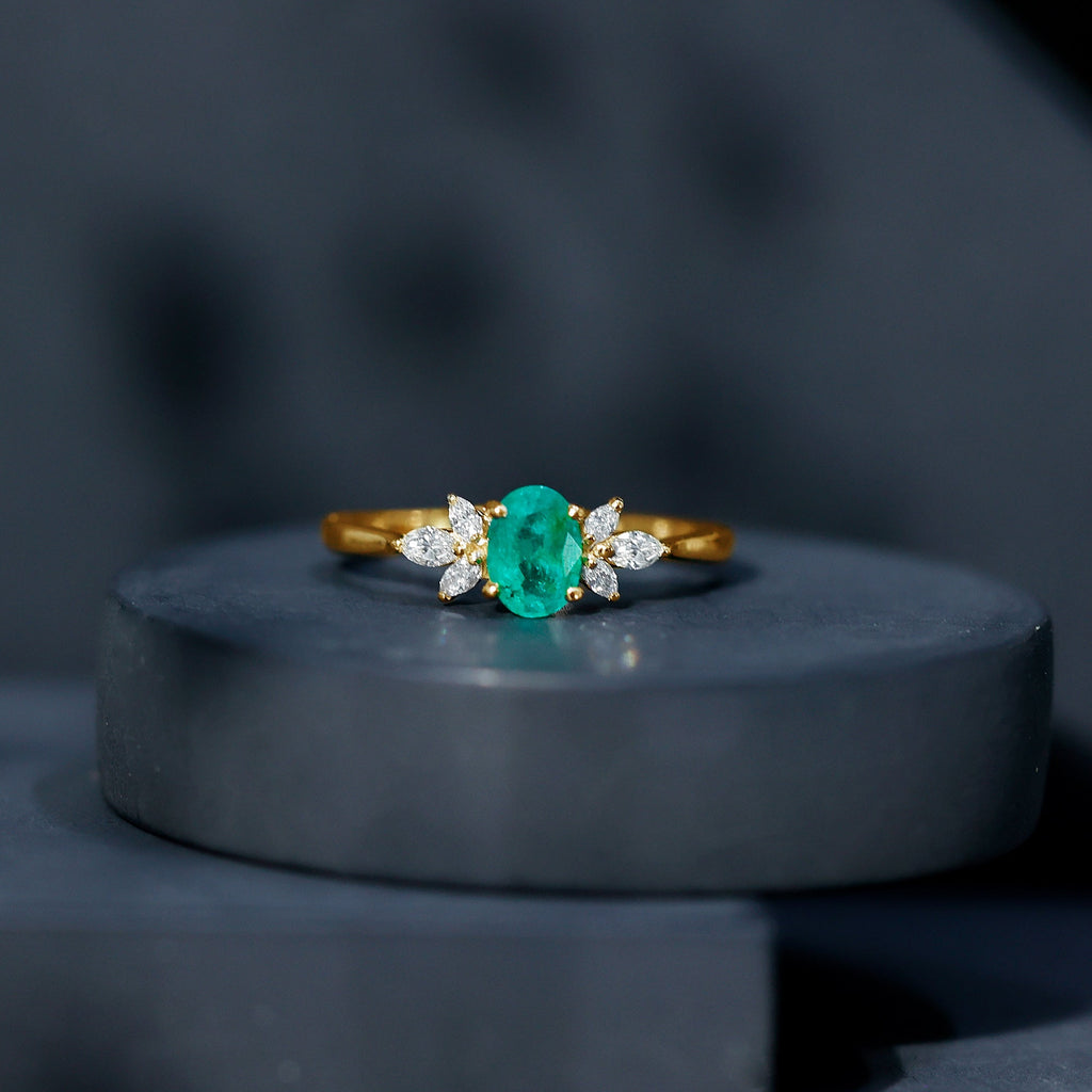 Oval Shaped Emerald Engagement Ring with Marquise Diamond Trio