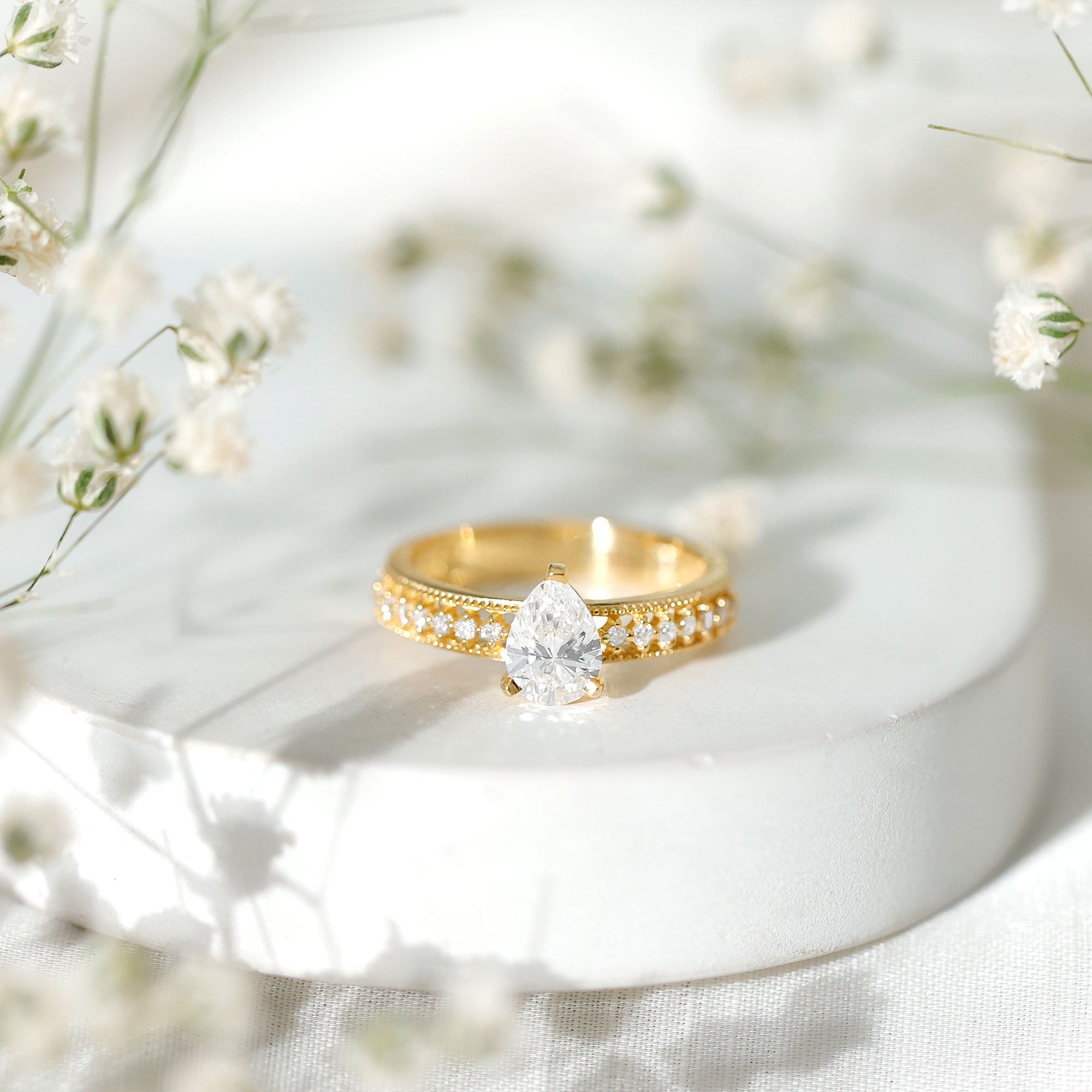 Pear Shaped Moissanite Solitaire Engagement Ring with Beaded Design