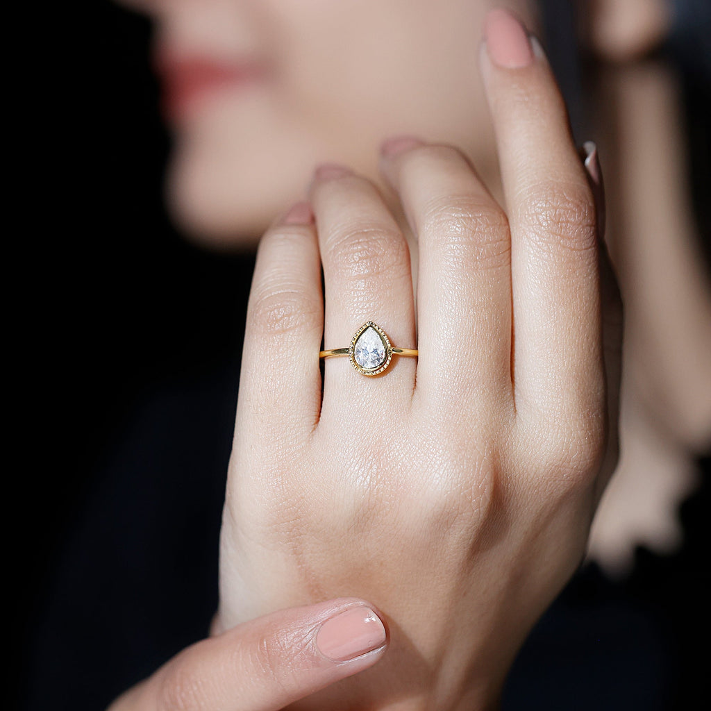 Pear Shaped Moissanite Solitaire Engagement Ring in Bezel Setting