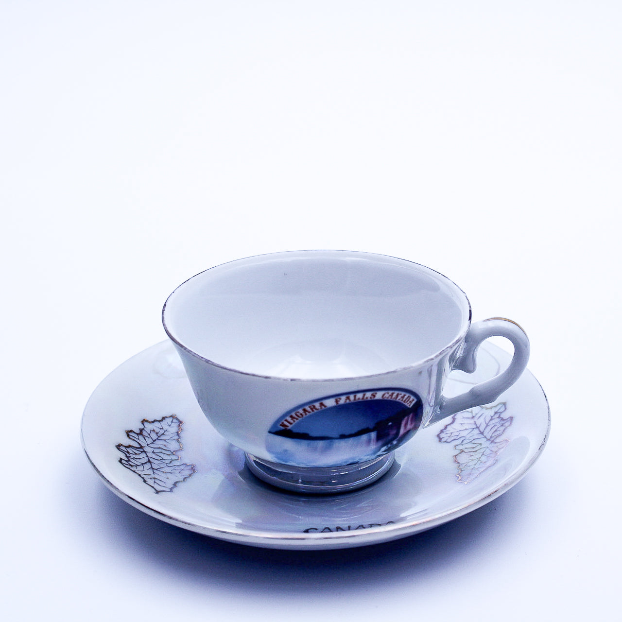 Iridescent Niagara Falls Teacup and Saucer — Gold Maple Leaves