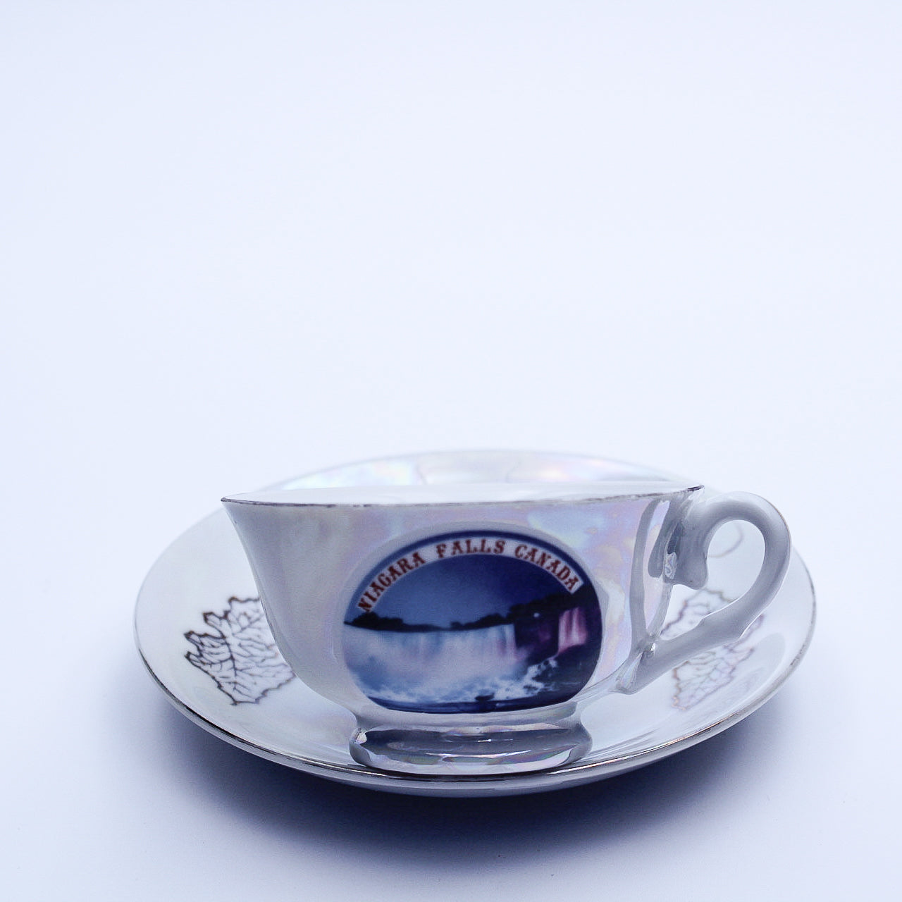 Iridescent Niagara Falls Teacup and Saucer — Gold Maple Leaves