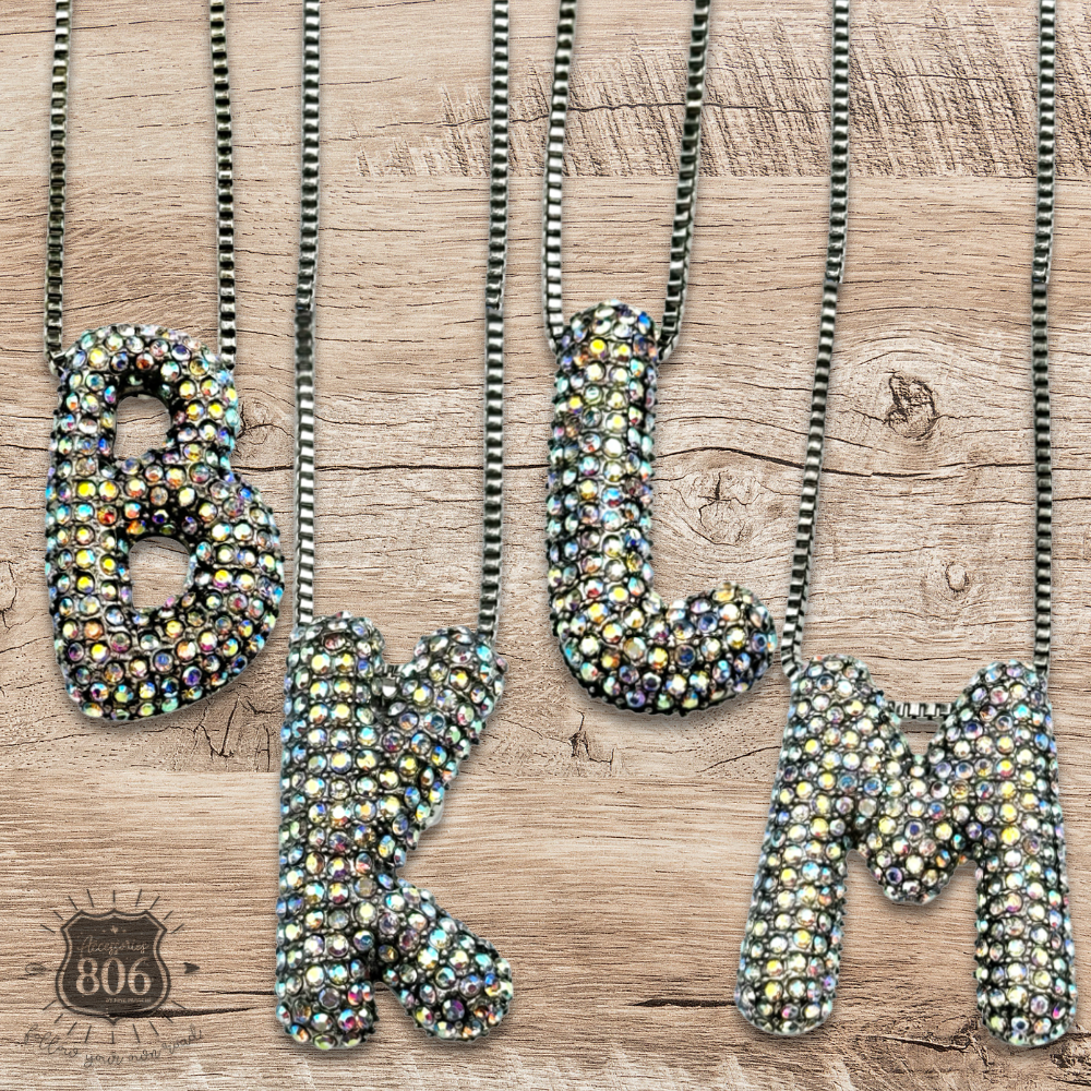 Rhinestone letter pendant on silver necklace
